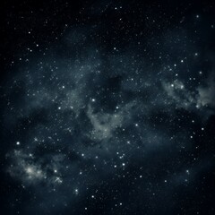 Obraz premium A starry night sky with a dark blue background and white stars scattered throughout. There are also some light blue nebulae in the sky.