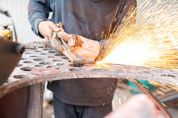 Workers waer leather gloves while using oxy-fuel cutting torches.