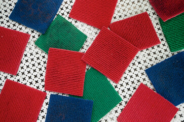 Fototapeta premium Square coasters in different colors made from carpet