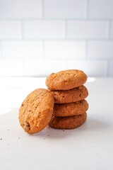 Cookies oatmeal raisin on white brick background