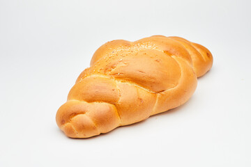 Soft golden braided bread with sesame seeds on a white background, perfect for food stock photos