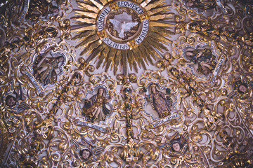 Baroque church ceiling details and gold filigree at Oaxaca, Mexico.