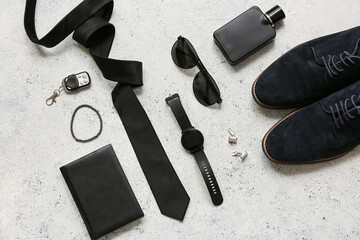 Set of male accessories with tie, wrist watch and sunglasses on white grunge background. Top view