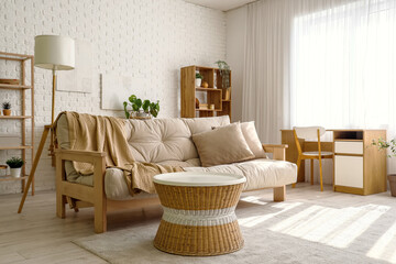 Interior of light living room with white sofa and coffee table