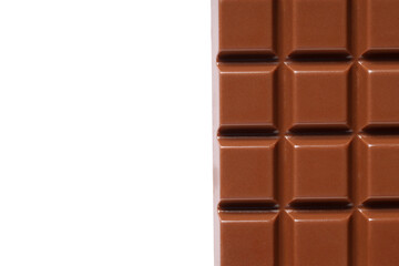Tasty milk chocolate bar on light background, closeup