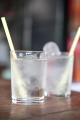 Glass of water on a wood table in a restaurant