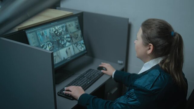 Caucasian female safeguard sits at workplace in office, works using computer. PC monitor with CCTV cameras video footage. African American security guard gives keys to colleague. Surveillance system.