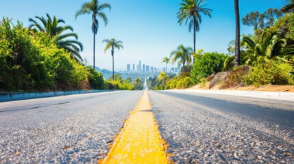 A scenic road surrounded by greenery leads directly toward the iconic skyline of downtown Los Angeles