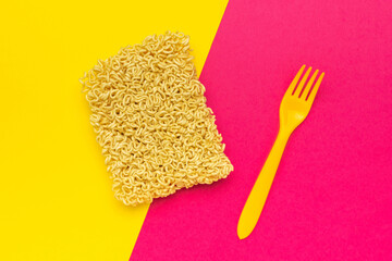 Instant Noodles with Yellow Fork on Vibrant Dual-Colored Background