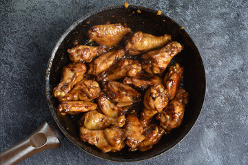 Asian style grilled chicken wings in soy-honey sauce