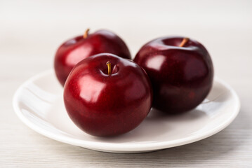 Fresh red plum on white background