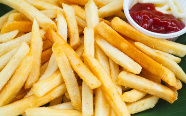 Delicious french fries on eco-friendly plate with ketchup for dipping.