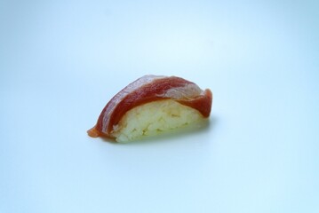 A classic Japanese dish, salmon nigiri sushi, isolated on a clean white background.