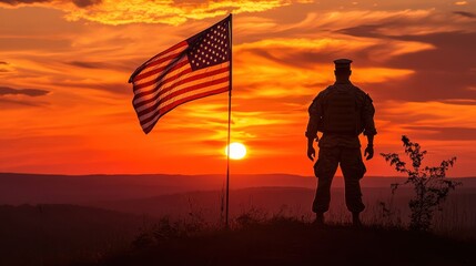 Naklejka premium Silhouetted Soldier Saluting American Flag at Sunset.