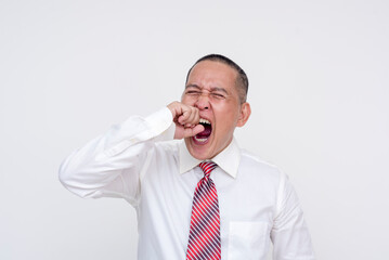 A middle aged asian manager yawning a lot after a long day. Isolated on a white background.