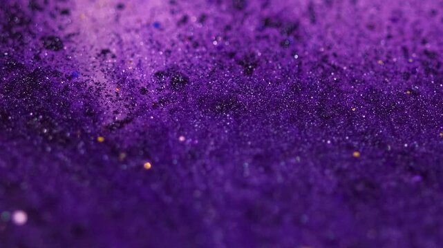 Liquid shimmer flow. Sparkling paint. Defocused purple black color shiny glitter particles texture ink spill emulsion gloss fluid flow motion abstract art background.