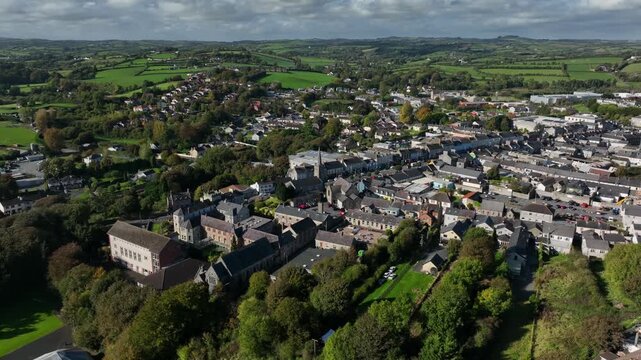 Carrickmacross Town, County Monaghan, Ireland, November 2022. Drone orbits counter clockwise while pushing closer to St Finbarr&rsquo;s Church of Ireland surrounded by town houses at the top of main street.