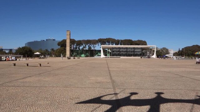silhouette of the sculpture Dois Candangos and building of Supreme Federal Court on background. Brasilia, Brazil
