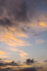 Colorful twilight sky with orange clouds and dark shadows.