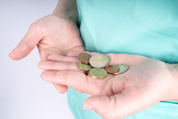 Nurse with euro coins in hands