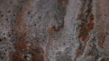 Ink emulsion. Glitter gel liquid sparkling mix. Defocused shiny abstract art background paint spill bronze gray brilliant color texture.