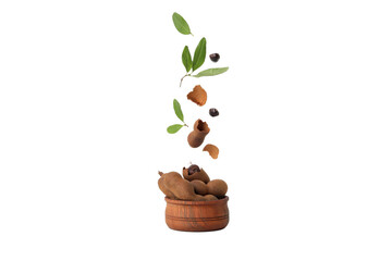 PNG, Ripe tamarind with leaves in a bowl, isolated on white background