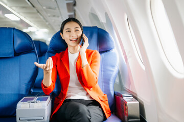 Asian Woman Working on Tablet During  in first class, multitasking with Flight Travel in style, work