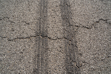 Street with black drag marks from cars