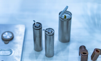Metal parts with shiny steel cylindrical surface closeup. disassembled lithium ion form factor cell...