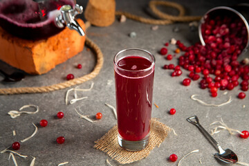Cranberry juice with berries on the table