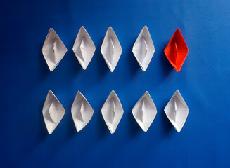 Red Paper Ship Are Different From Others. Business for Innovative And Be Different concept.