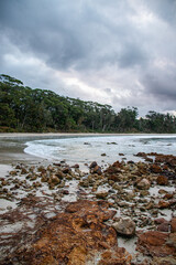 Rocks, beach, and clouds