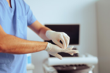 Doctor Putting on Surgical Gloves Before Medical procedure. Surgeon getting ready for the surgery...