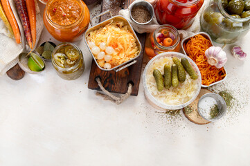 Fermented products on a wooden background. Pickled vegetables in jars