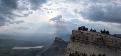 Old Truck 4x4 Offroad Adventure Vehicle on top of Rocky Mountain Top. 3d Rendering Composite