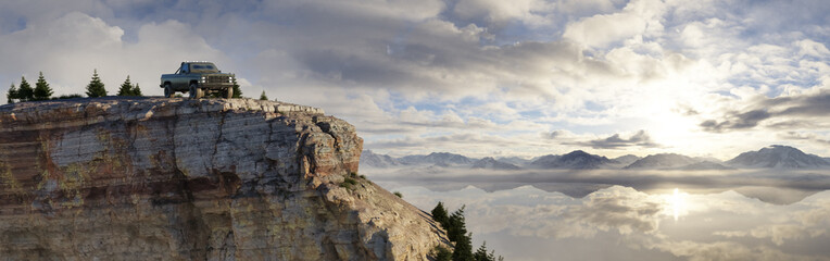 Fototapeta premium 4x4 Truck on Cliff Overlooking Majestic Mountain Landscape
