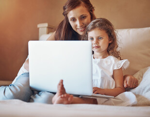 Fototapeta premium Mother, child and relax on bed with laptop for streaming subscription, cartoon and online video in home. Happy family, woman and girl in bedroom with technology for social media, bonding and kid film