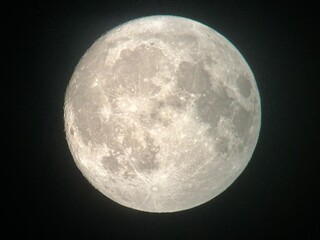 night sky with full moon view through telescope on the eve of supermoon and blue moon rise in the sky in august 2024