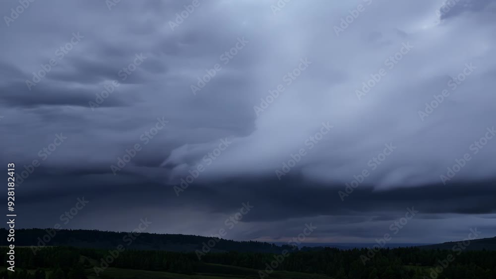 Poster sun setting, storm clouds loom over dark forest, creating spooky scene. gray clouds hint at thunders