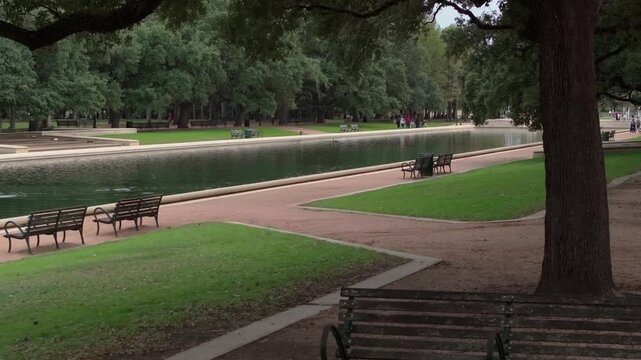 B-roll shot of Reflection Pool with benches in Hermann Park in Houston, TX