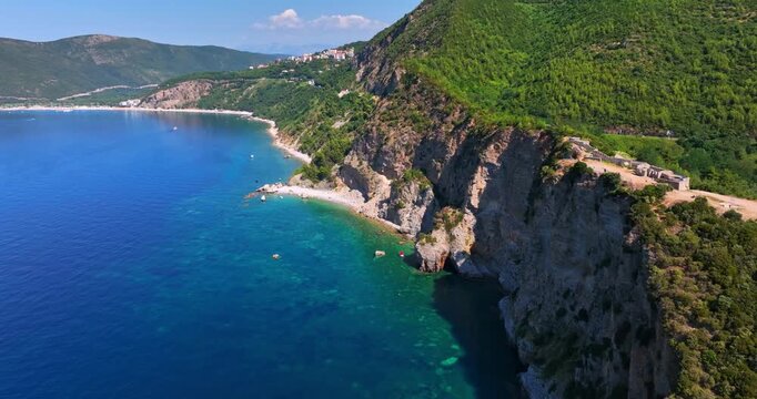 Aerial view passing the Fort Mogren ruins on the coast of Budva, Montenegro