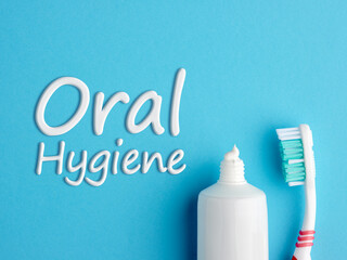 The word Oral Hygiene written with toothpaste on blue background.