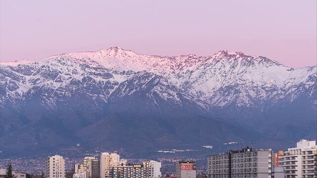 Day to night Time lapse, sunset colors in the Andes mountain range, in Santiago, Chile.
