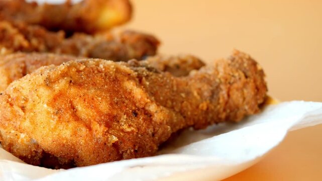  fried chicken fillets on plate on blue background 