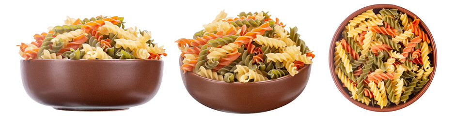 Raw tricolor fusilli or rotini pasta (traditional, tomato and spinach taste) in clay bowl isolated on white background. File contains clipping path.
