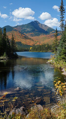 Obraz premium Majestic Mountain Lake in Autumn Forest with Clear Sky and Reflections