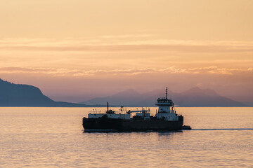 Boat at sunset along the inside passage on the coast of British Columbia and southeast Alaska 