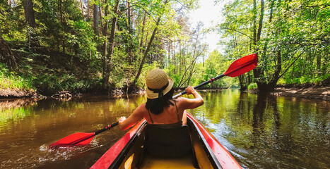Back view Kayaking couple in river. POV of woman and man kayaking in beautiful landscape. Aquatic...