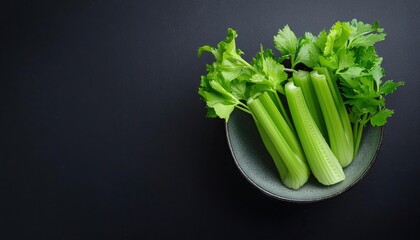 celery in a bowl on a black background