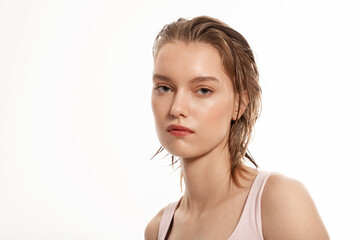 Beautiful young woman with wet hair and clear skin